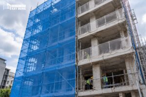 Lưới bao che và lưới an toàn gắn trên giàn giáo công trình để phân biệt chức năng